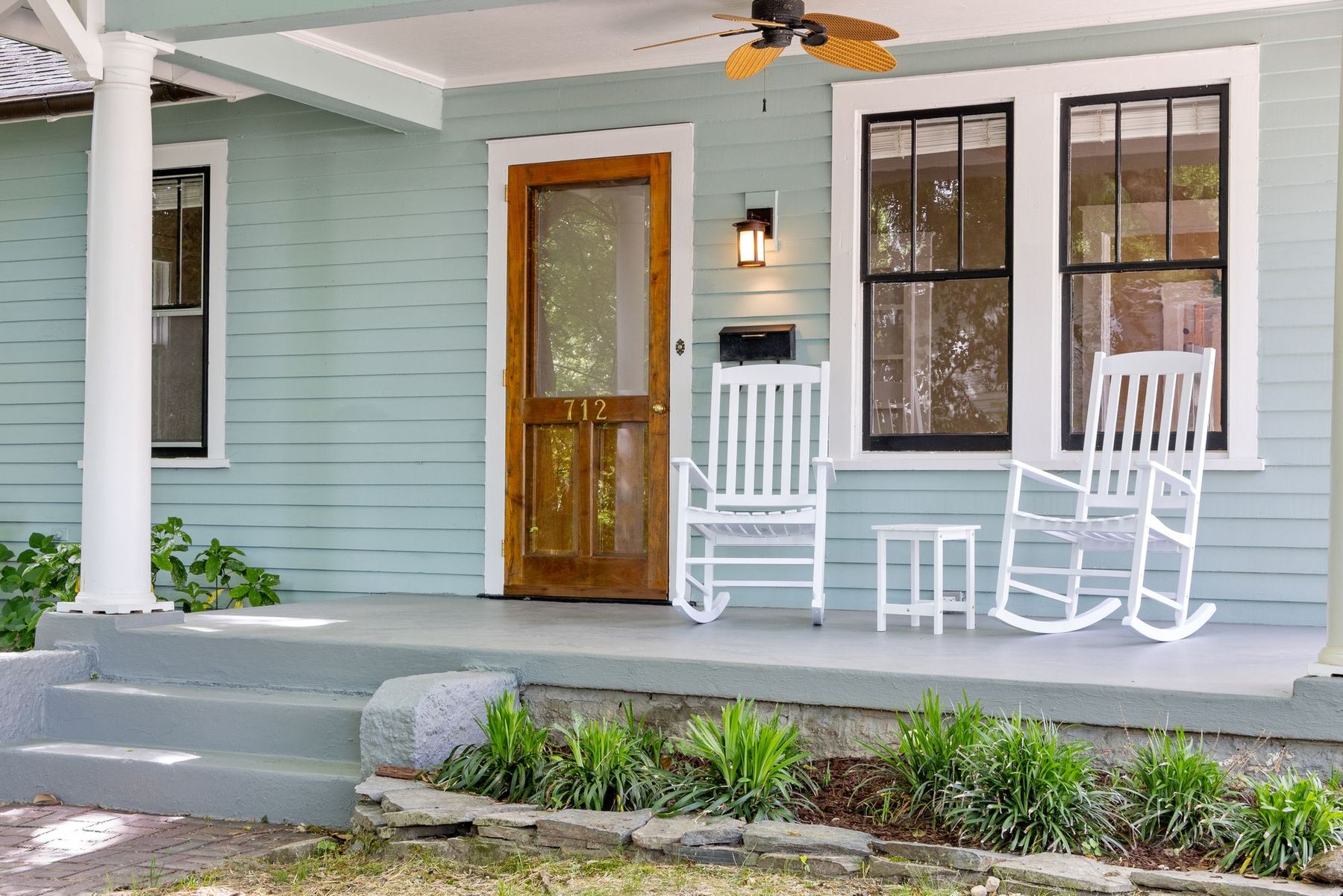 The covered front porch of one of the homes